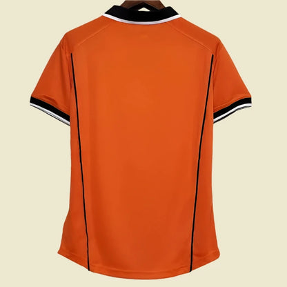 Orange Netherlands 98 World Cup home shirt with black accents on a hanger against a white background