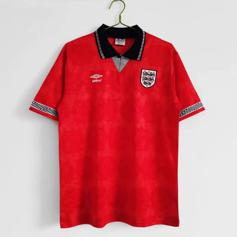 Red England 1990 away shirt with a logo on a white background