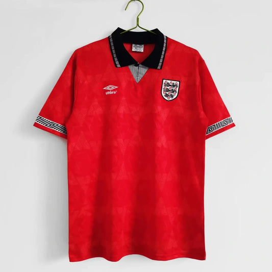 Red England 1990 away shirt with a logo on a white background