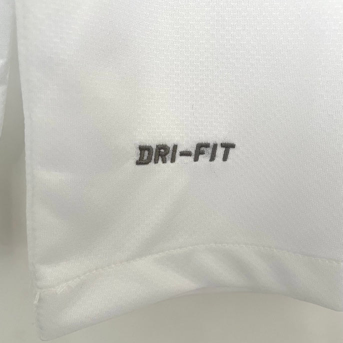 Close-up of a white Santos 11/12 long sleeve home shirt with 'DRI-FIT' text on a light gray background