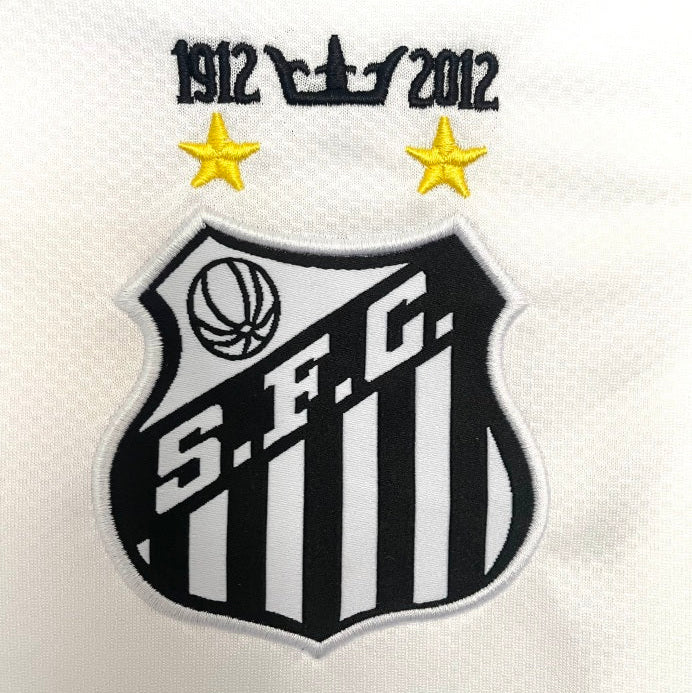 Soccer club logo with 'S.F.C.' and years on a Santos 11/12 long sleeve home shirt