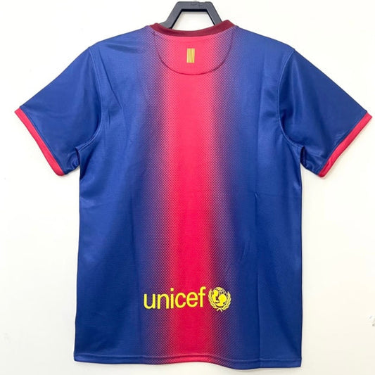 Blue and red Barcelona 12/13 home shirt  with Unicef logo on a white background