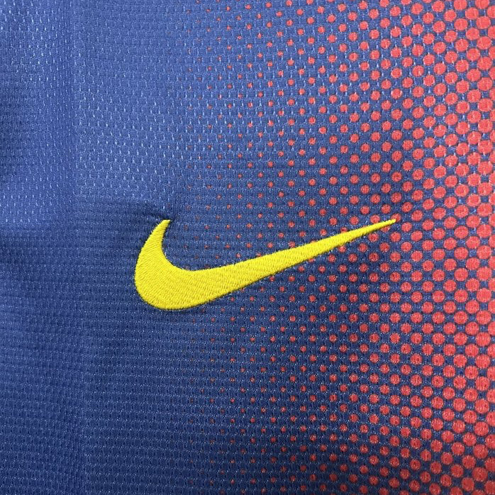 Close-up of a Nike logo on a Barcelona 12/13 home shirt  with blue and red pattern