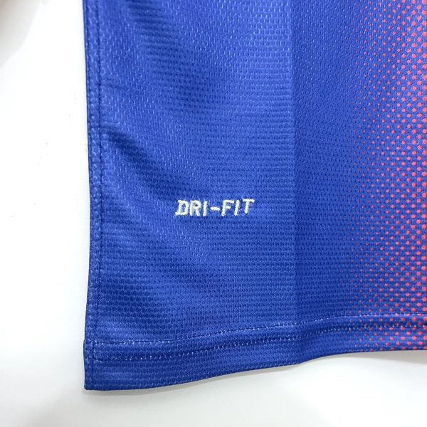 Close-up of Barcelona 12/13 home shirt  with 'Dri-FIT' logo on a white background