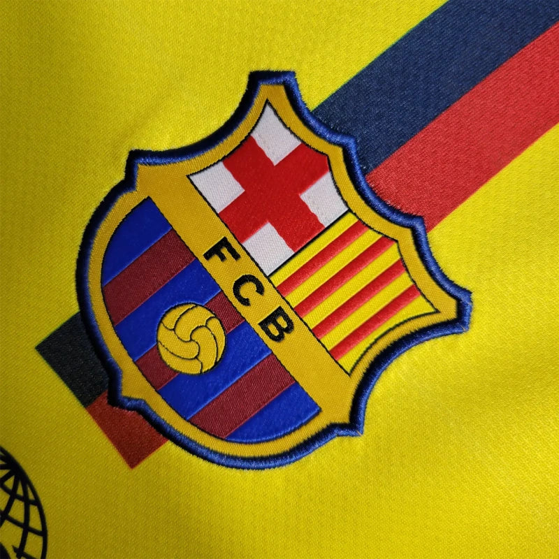 Close-up of FC Barcelona logo on a Barcelona 08/09 long sleeve away shirt with yellow, red, and blue colors.