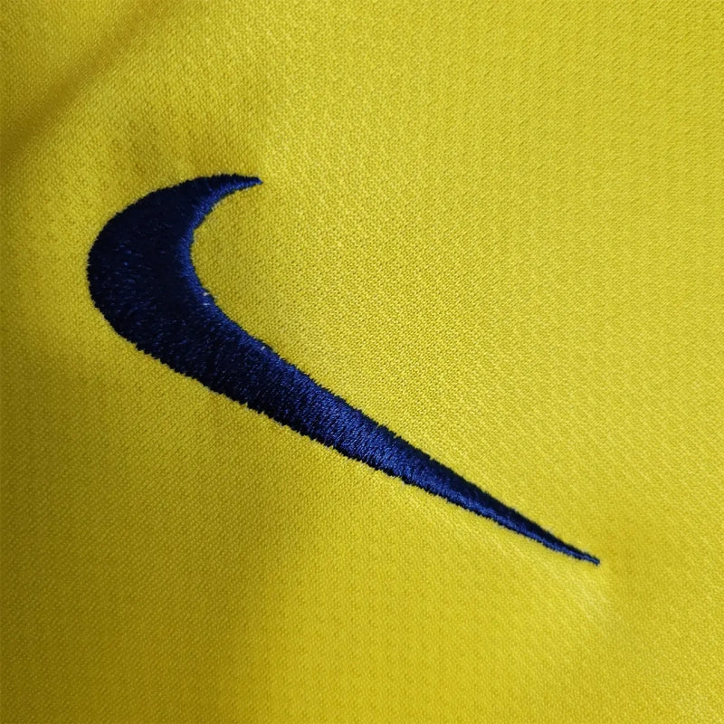Close-up of a blue Nike logo on a yellow Barcelona 08/09 long sleeve away shirt