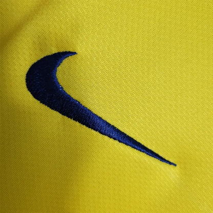 Close-up of a blue Nike logo on a yellow Barcelona 08/09 long sleeve away shirt
