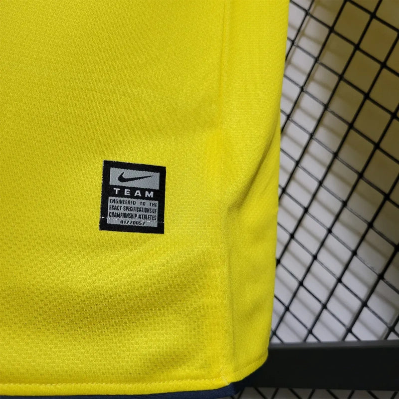 Yellow Barcelona 08/09 long sleeve away shirt with a black and white label on a black and white checkered background