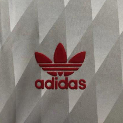 Gray Liverpool 89-91 away shirt with red Adidas logo on a hanger