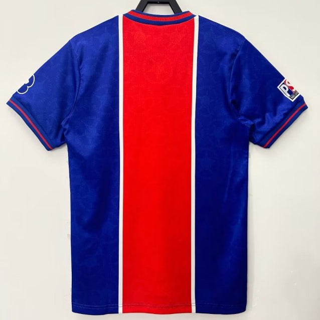 Blue and red psg 95/96 home shirt on a hanger against a white background