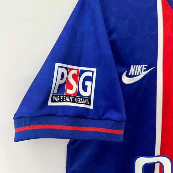 Blue psg 95/96 home shirt with PSG and Nike logos on a white background