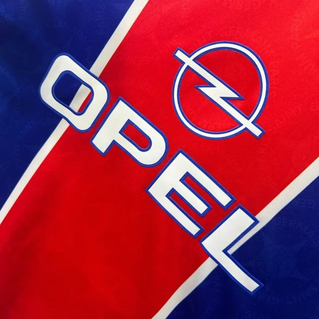 Opel logo on a red and blue psg 95/96 home shirt