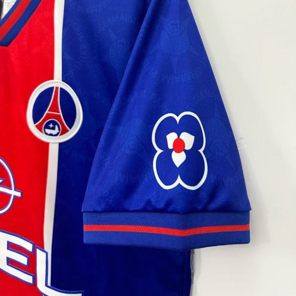 Red and blue psg 95/96 home shirt with logos on a white background