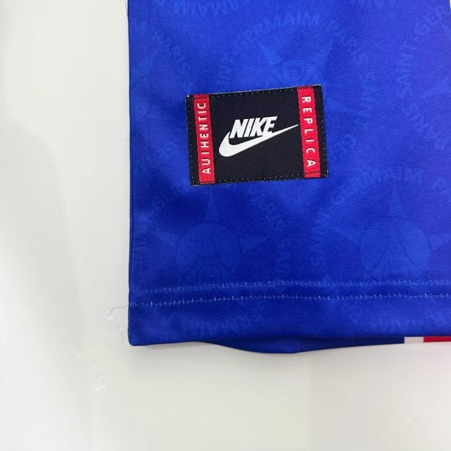 Blue psg 95/96 home shirt with a Nike replica label on a white background