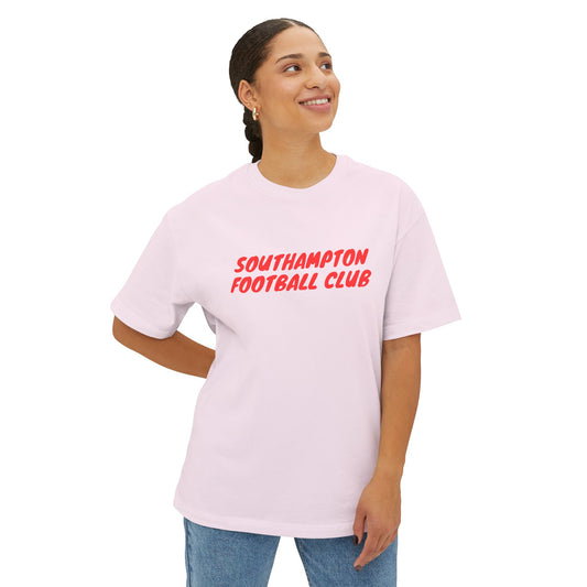 Person wearing a light pink t-shirt with 'Southampton Football Club' text on a white background