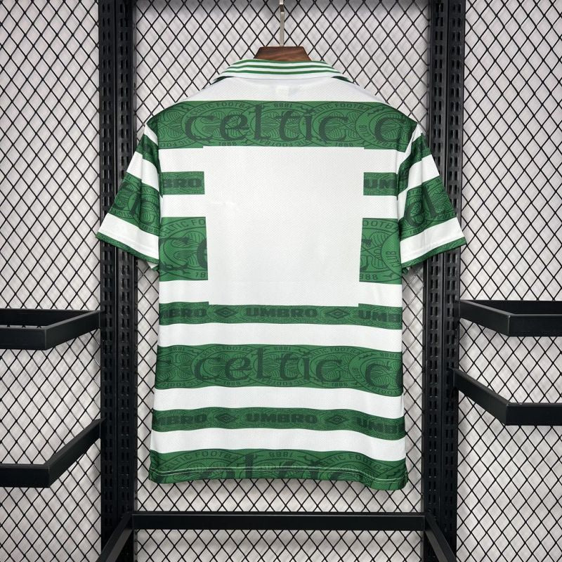 Green and white striped Celtic 95-97 home shirt with 'Celtic' branding on a rack.
