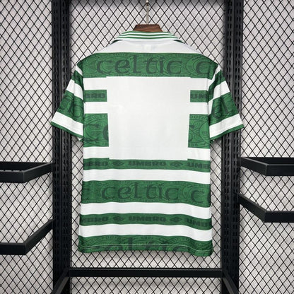 Green and white striped Celtic 95-97 home shirt with 'Celtic' branding on a rack.