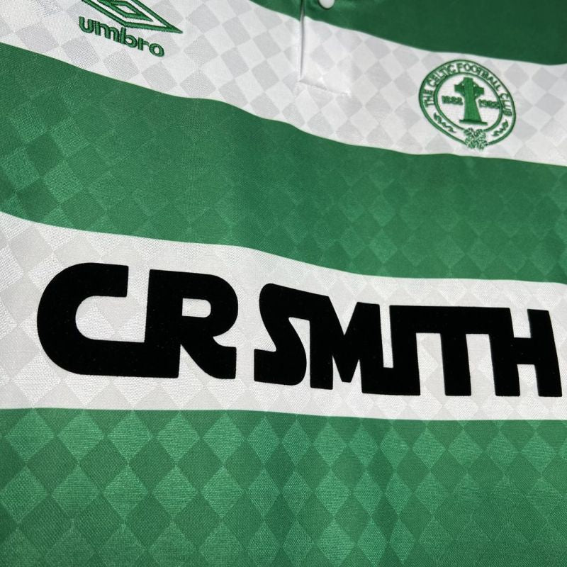 Green and white Celtic 87/88 home shirt with 'CR Smith' branding and a logo on a checkered background.