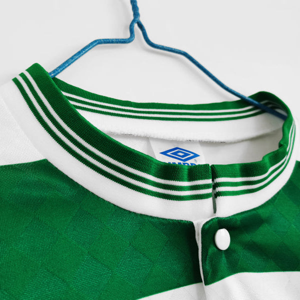 Green and white Celtic 87/88 long sleeve home shirt on a hanger with Umbro logo.