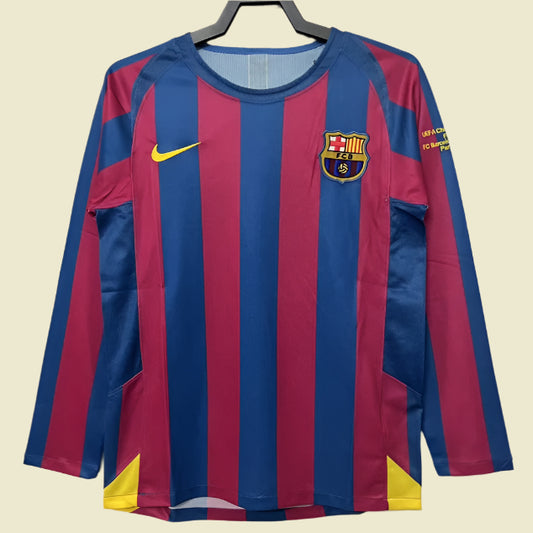 Barcelona 05/06 champions league shirt with blue and red stripes on a hanger against a beige background 