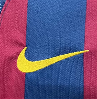 Close-up of a Barcelona 05/06 champions league shirt  with blue and red design and Nike logo.