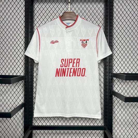 White Sevilla 91/92 Super Nintendo home shirt with red accents and 'Super Nintendo' text, hanging on a rack.