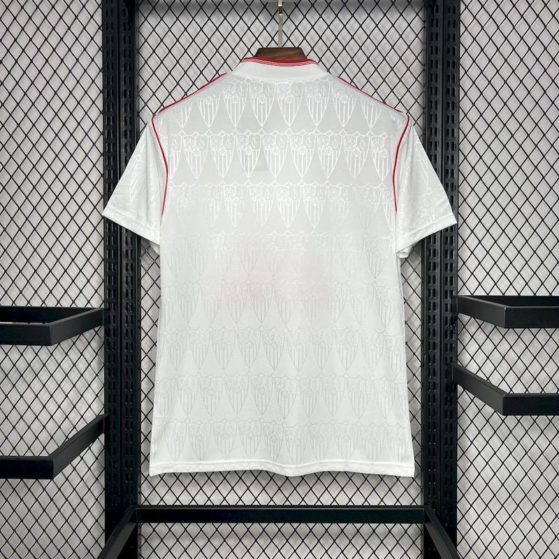 White Sevilla 91/92 Super Nintendo home shirt  with red accents hanging on a rack.