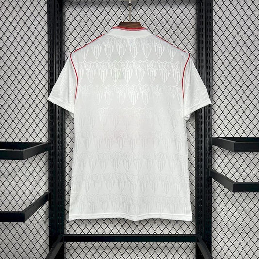 White Sevilla 91/92 Super Nintendo home shirt  with red accents hanging on a rack.