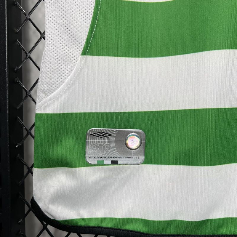 Green and white striped Celtic 01-03 home shirt with a brand logo on a black chain-link background
