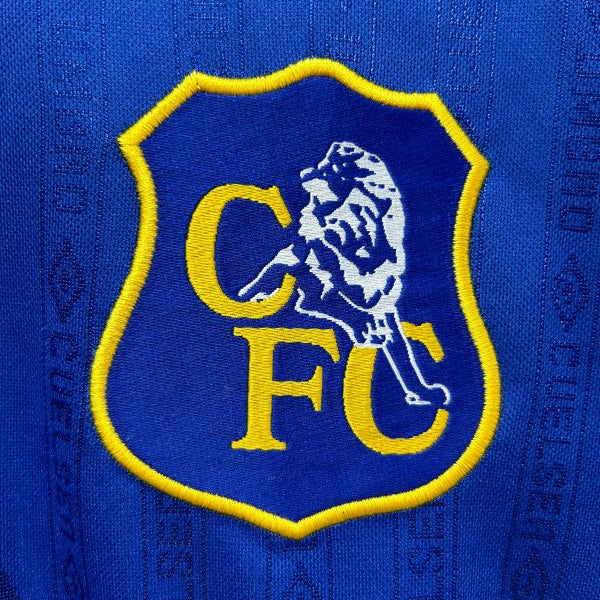 Close-up of a Chelsea FC logo on a blue Chelsea 95-97 home shirt
