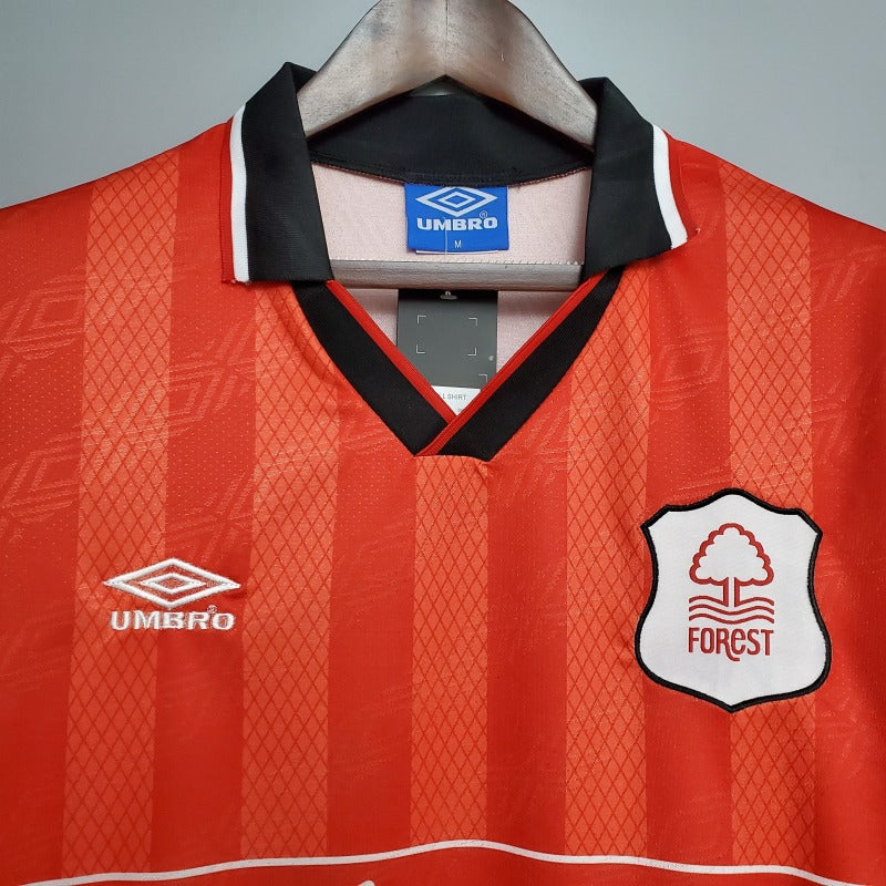 Red Nottingham forest 95/96 home shirt with Umbro logo and Forest badge on a gray background