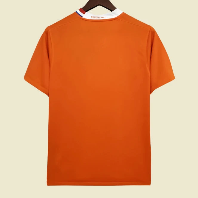 Orange Netherlands 2008 home shirt on a hanger with a white background