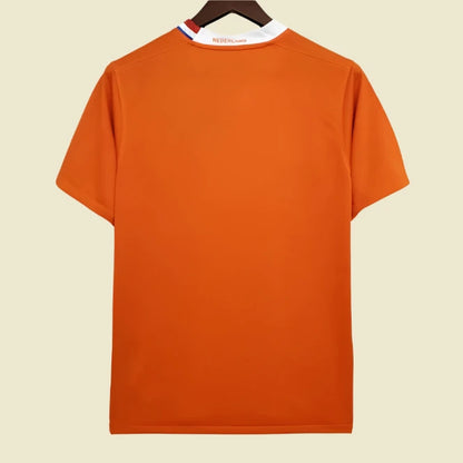 Orange Netherlands 2008 home shirt on a hanger with a white background