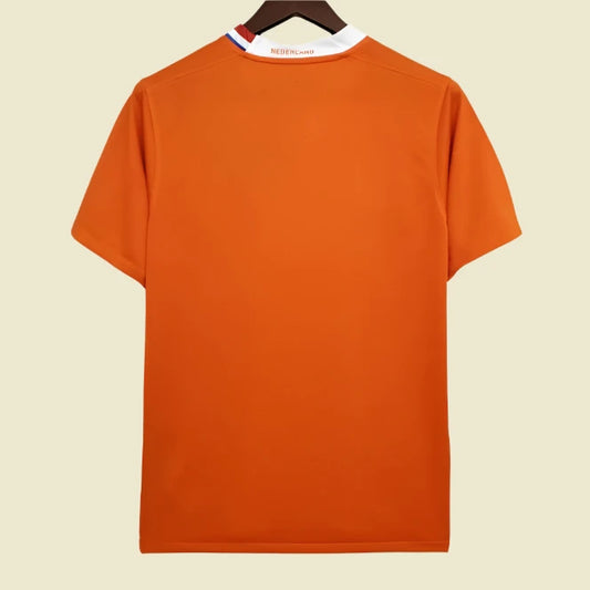 Orange Netherlands 2008 home shirt on a hanger with a white background