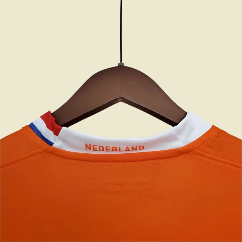 Orange Netherlands 2008 home shirt with 'Nederland' text on a hanger against a gray background
