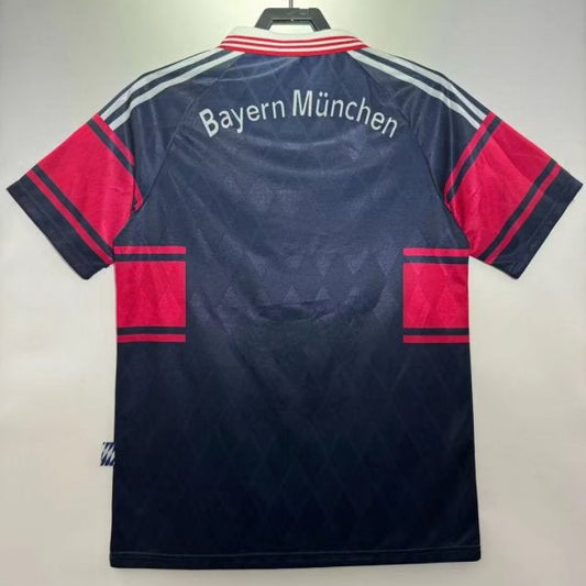 Back view of a Bayern Munich sports jersey on a hanger against a plain background