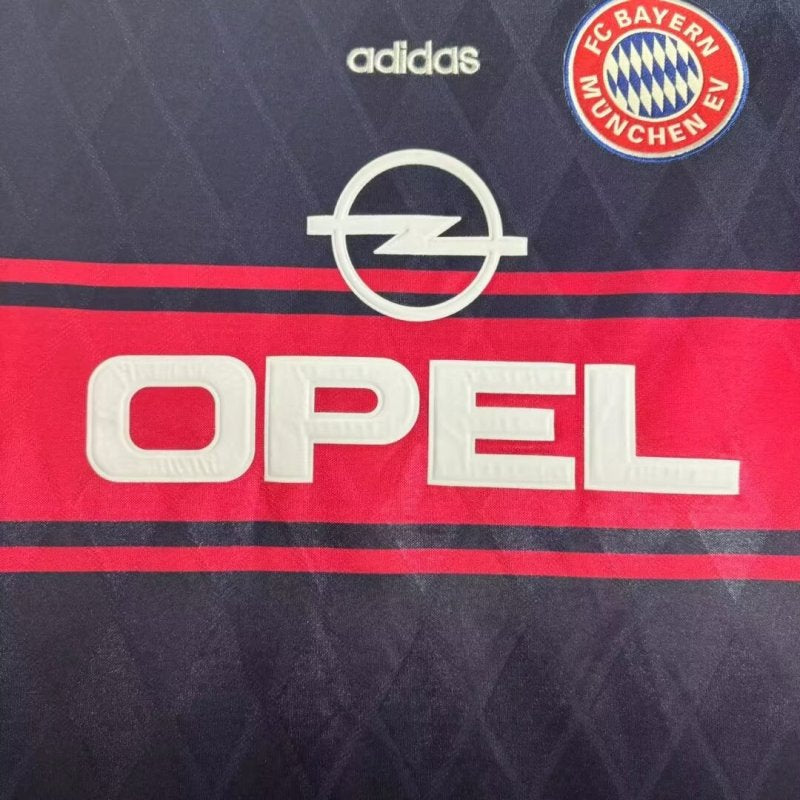 Close-up of a Bayern Munich 97/98 home shirt with Adidas, Bayern Munich, and Opel logos.