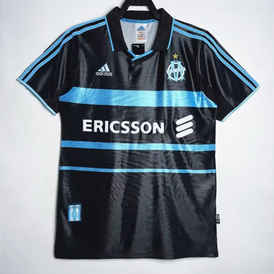 Black Marseille 99/00 third shirt with blue accents and visible branding on a white background