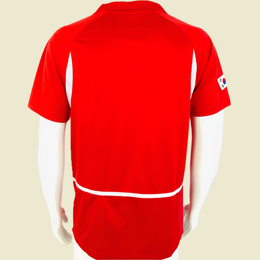Red South Korea 2002 home shirt with a logo on the sleeve against a white background