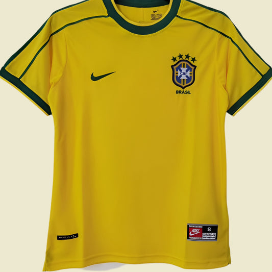 Yellow Brazil soccer jersey with Nike logo on a hanger against a white background