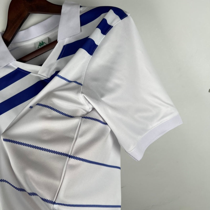 White Porto 85/86 away shirt with blue stripes on a hanger against a neutral background