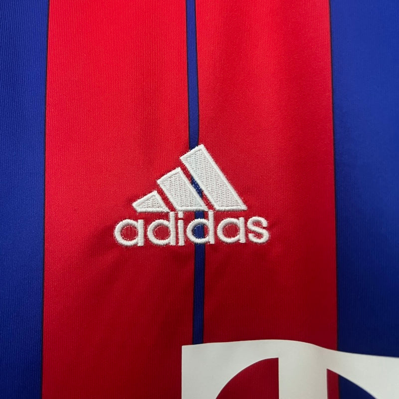 Close-up of Adidas logo on a red and blue Bayern Munich 14/15 home shirt
