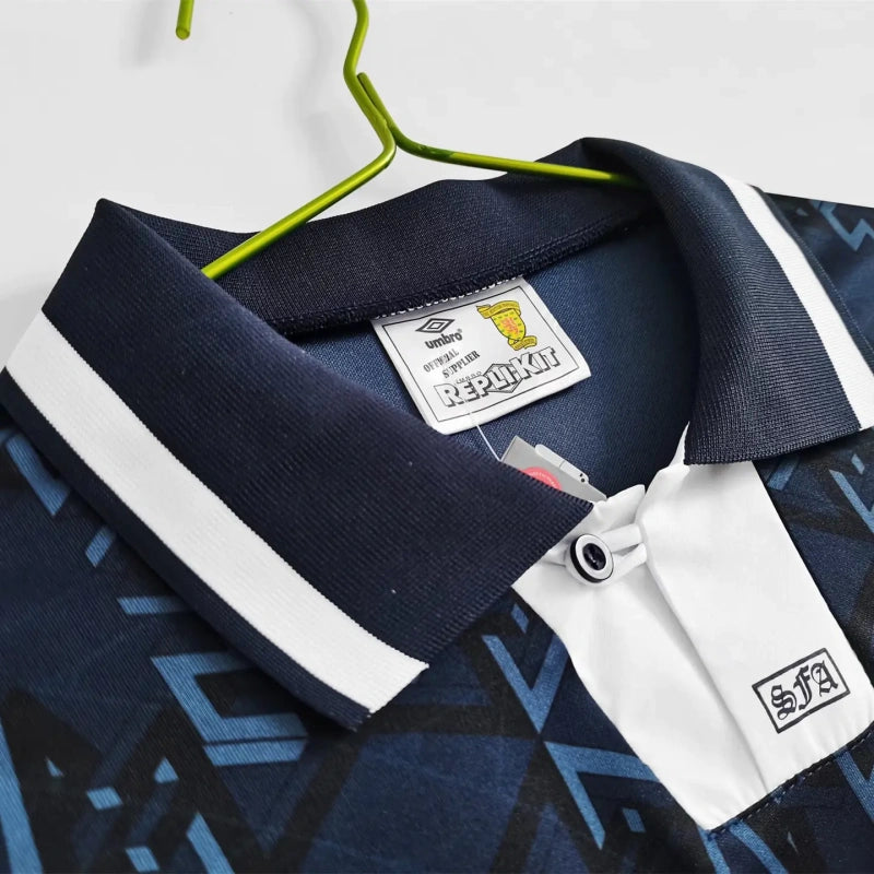 Navy and white Scotland 1992 home shirt with a brand label on a hanger