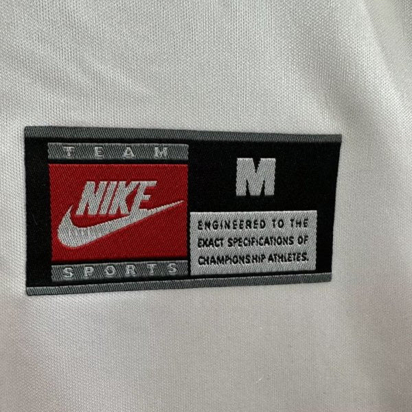 Nike sports label on a PSG 98/99 away shirt