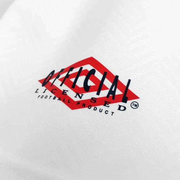 Close-up of a white England 1994 home shirt with 'Official Licensed Football Product' text and logo.