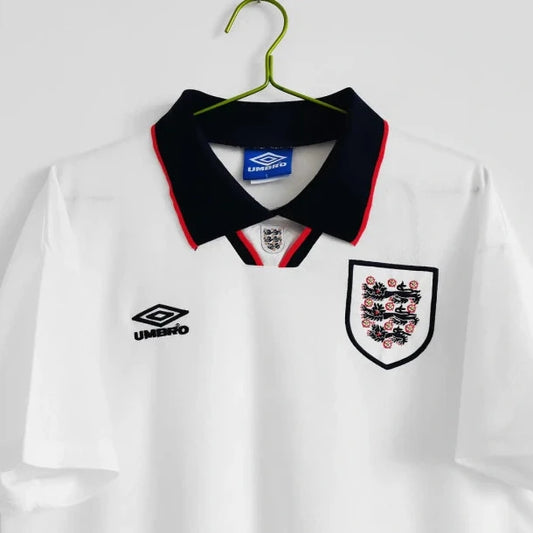 White England 1994 home shirt with black collar and England national team logo on a hanger