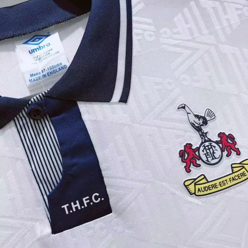Navy and white Tottenham 91-93 home shirt with a logo and 'T.H.F.C.' text on a textured background