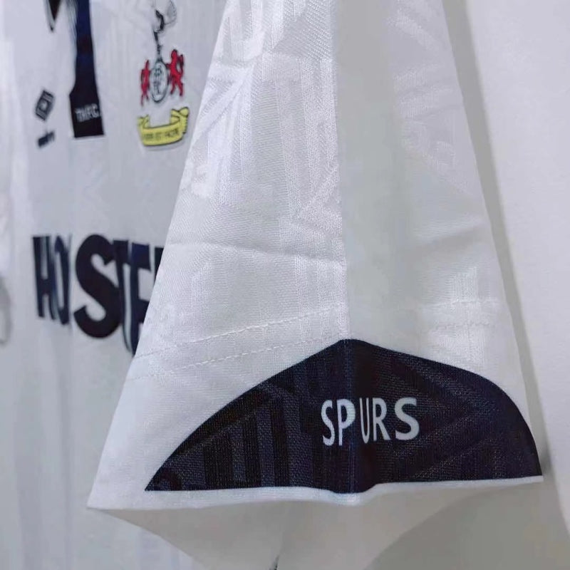 Close-up of a Tottenham 91-93 home shirt with 'SPURS' branding on a white background