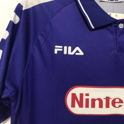 Fiorentina 98/99 home shirt with Fila and Nintendo logos on a hanger