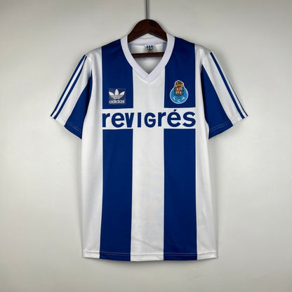 Blue and white striped Porto 90-93 home shirt with Adidas logo on a hanger against a light gray background